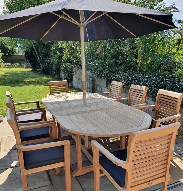 Teak garden dining set is amazing value - double extending table 1.8m to 2.4m, 8 x teak stacking chairs, free 3m parasol and cushions